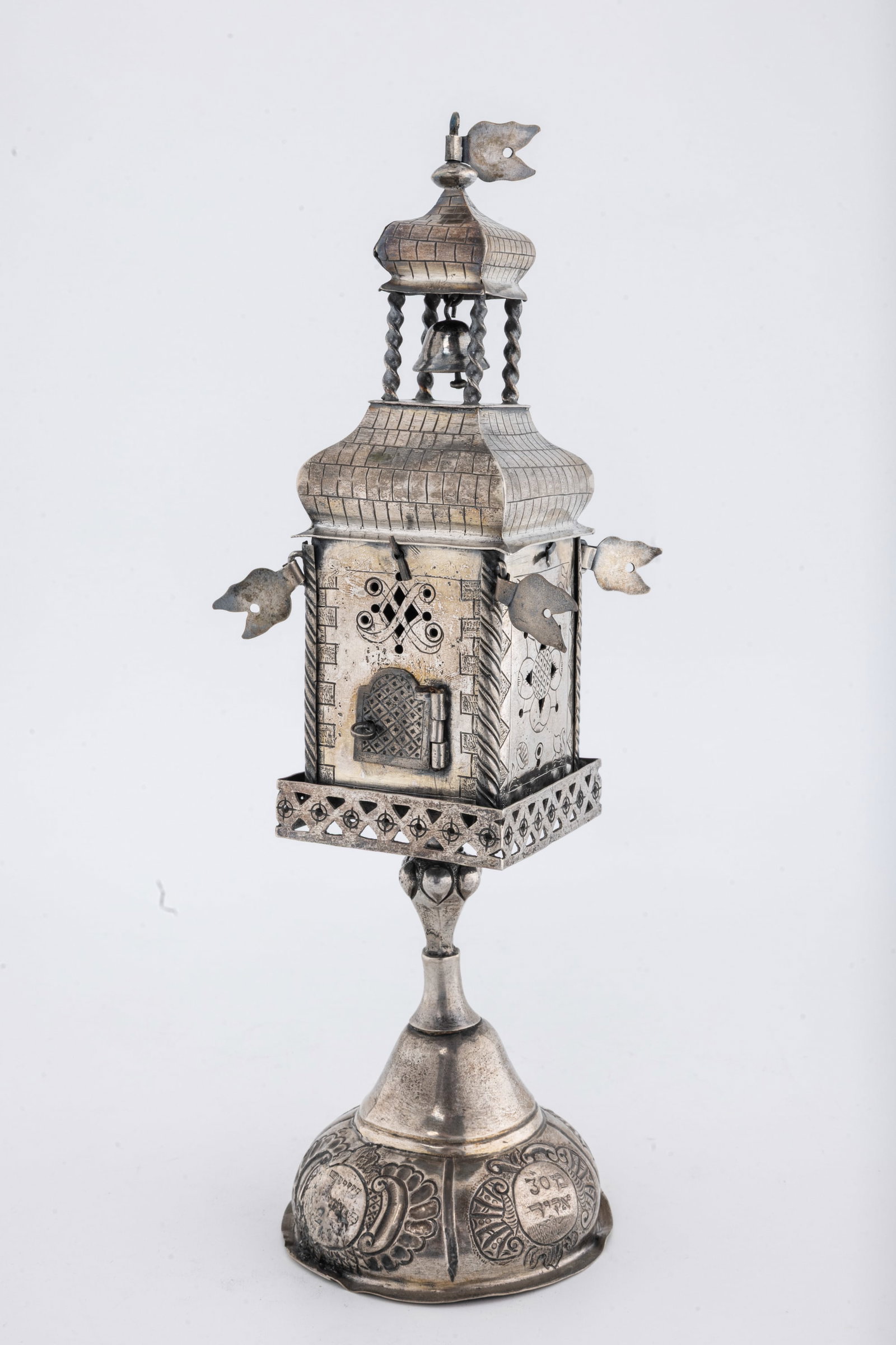 A RARE AND IMPORTANT SILVER SPICE TOWER. Poland,: On a domed base chased with scrolling designs and engraved in Hebrew Meir son of R' Yaakov and his wife Mrs A L . Upper portion is engraved witha partial blessing over the spices. Engraved with brickw