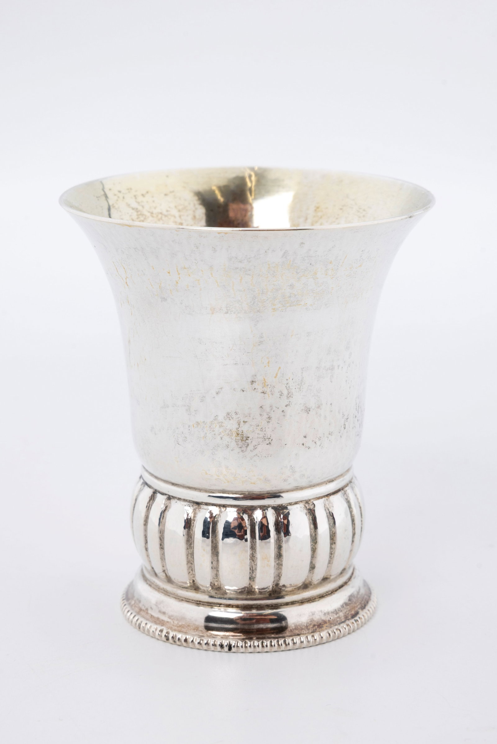 A SILVER KIDDUSH CUP BY WETZLER. Munich, Germany, c. 1910: On a round base with outwardly tapering design. Hand hammered and hand wrought. Marked 800, crown and moon, Wetzler and Munich. Of the highest quality. 3.5" and 111.8 grams