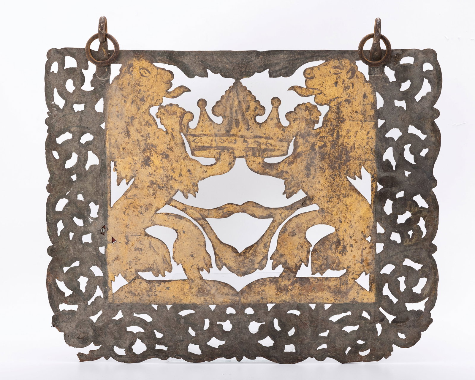 A METAL SYNAGOGUE DECORATION: Continental, c. 1840. Featuring two lions in latticework flanking a crown.