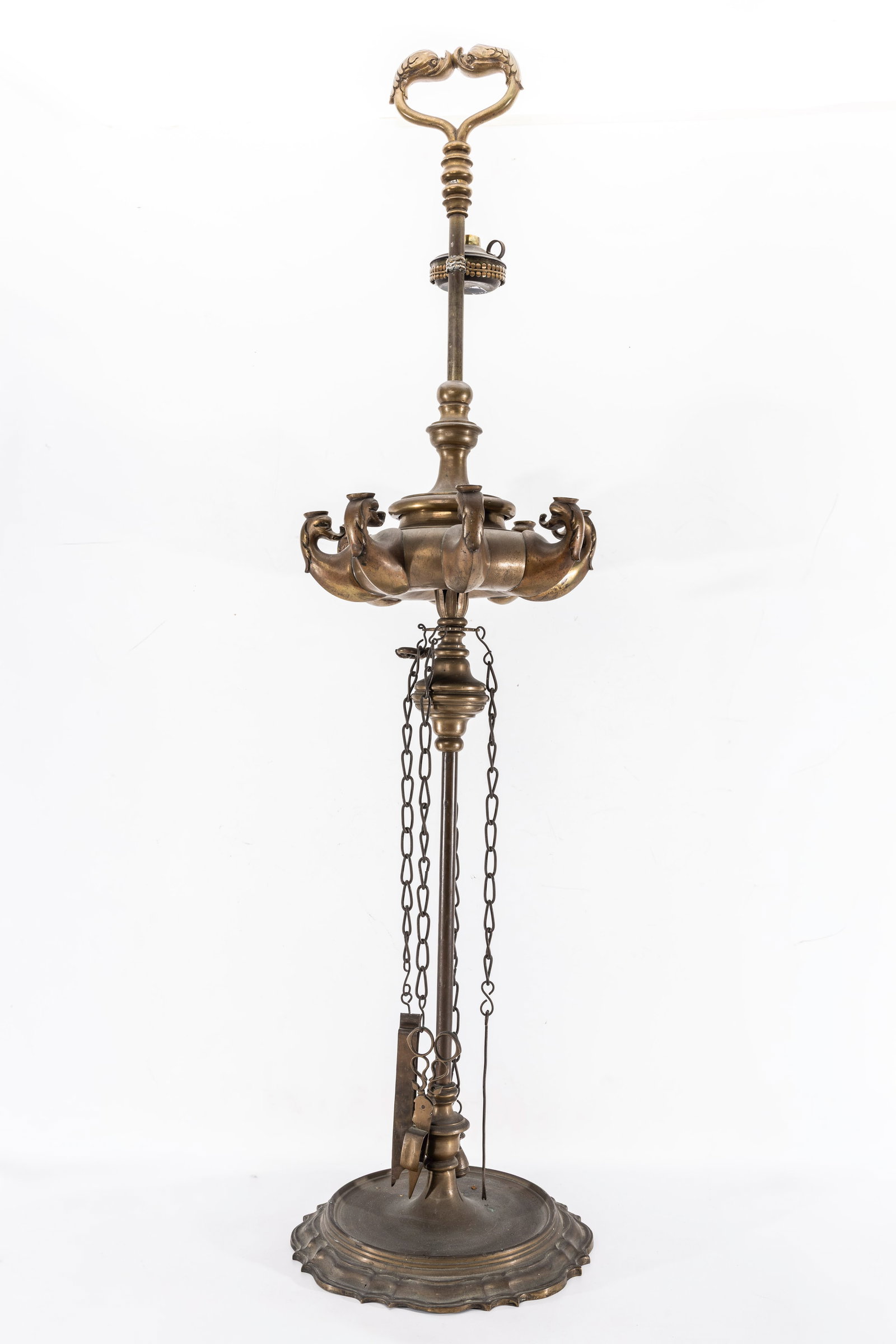 A LARGE BRASS OIL LAMP. India, early 20th century.: On a stylized rond domed base. With eight oil fonts and tools for lighting and wick removal. 45" tal.