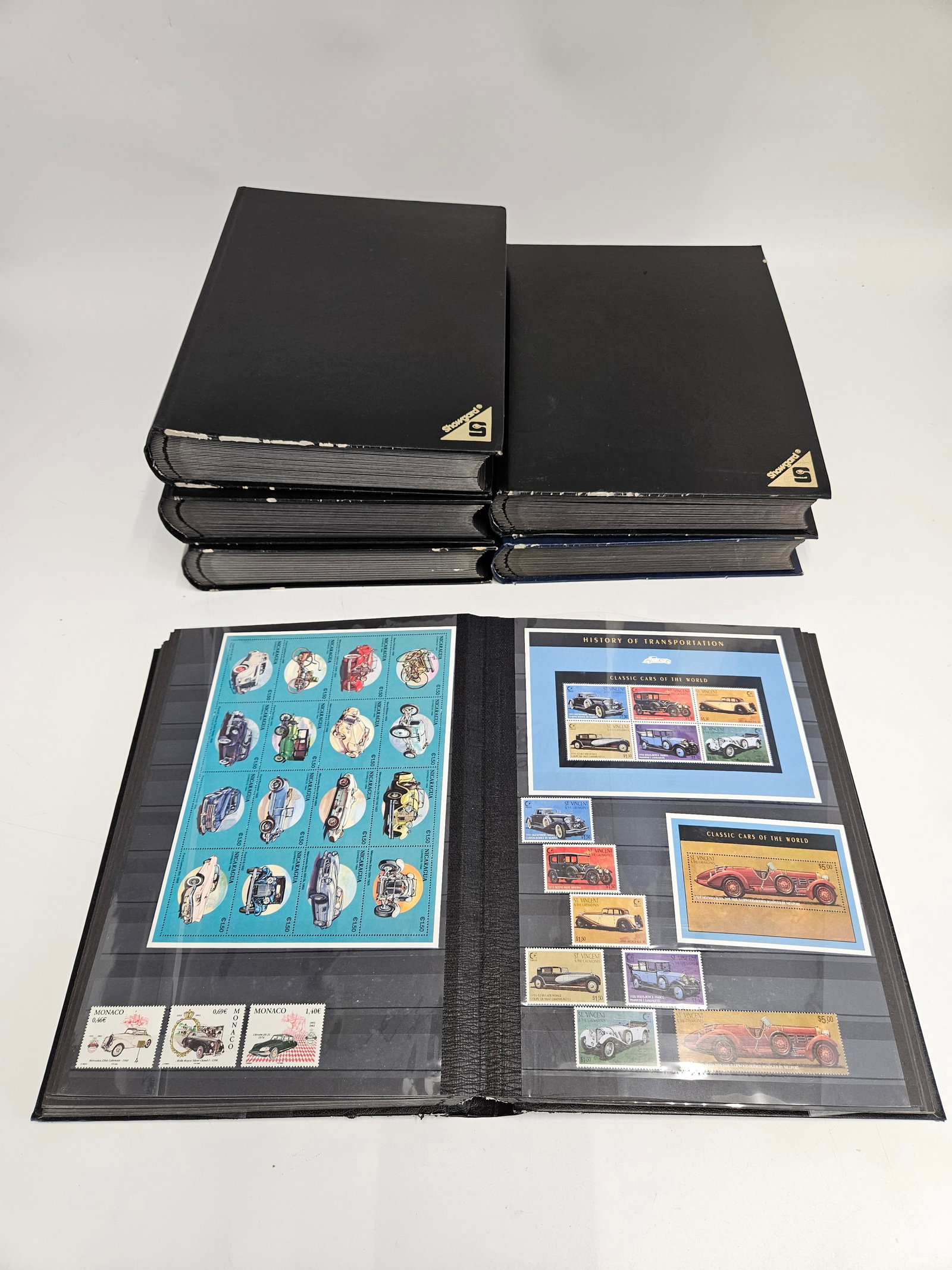 A LARGE WORLD STAMP COLLECTION - TRAINS, PLANES AND AUTOMOBILES.: Six albums with approximately 20 two sided pages each, filled with mint stamps from Monoco, Flaand Islands, UK, Nigeria, Russia, Guernsey, Bhutan and others.