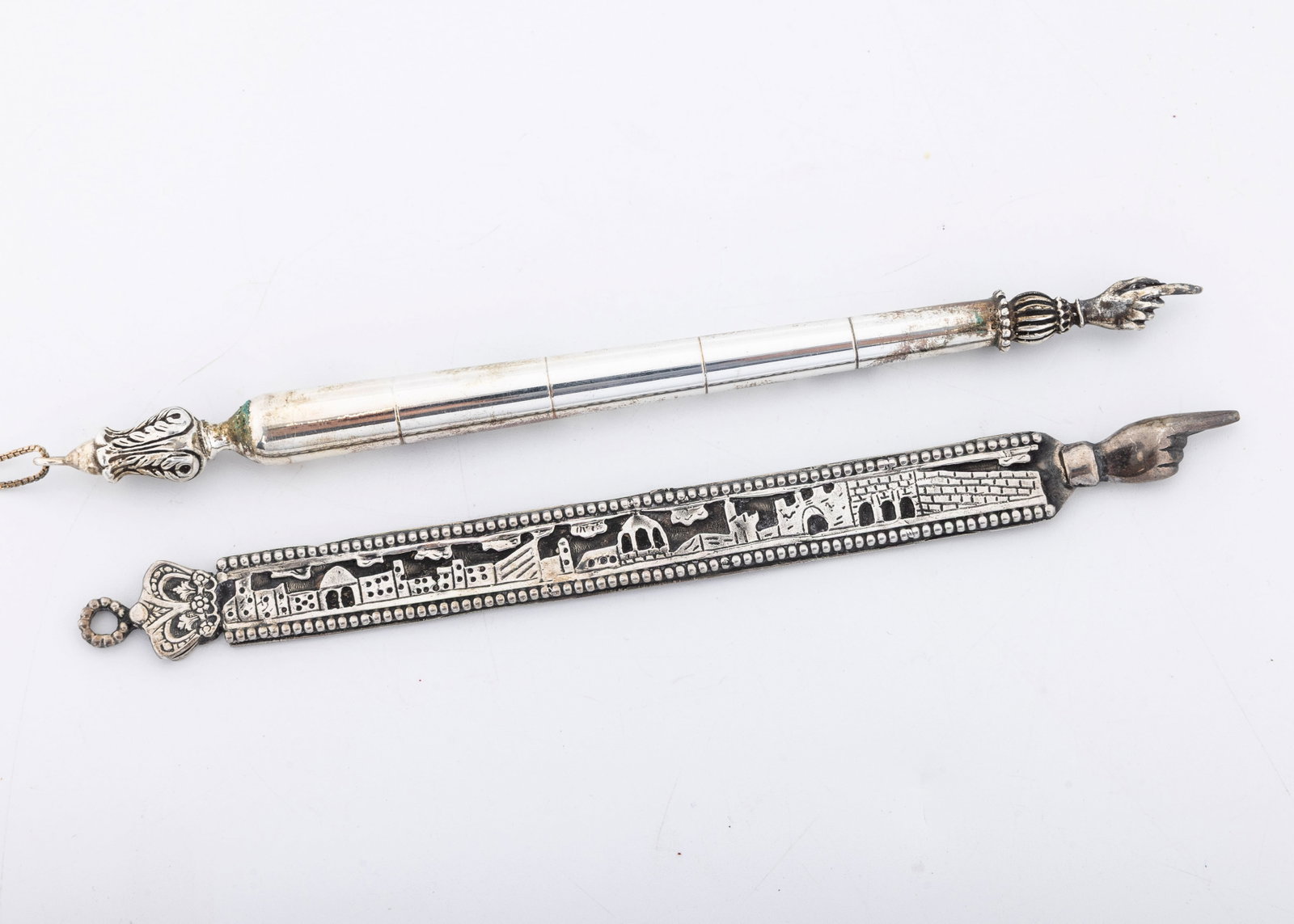 A STERLING SILVER "JERUSALEM" TORAH POINTER. Israel, modern: Flat and hand made. 42.9 grams and 7.2" long. Accompanied by a silver plated yad on a sterling silver chain.