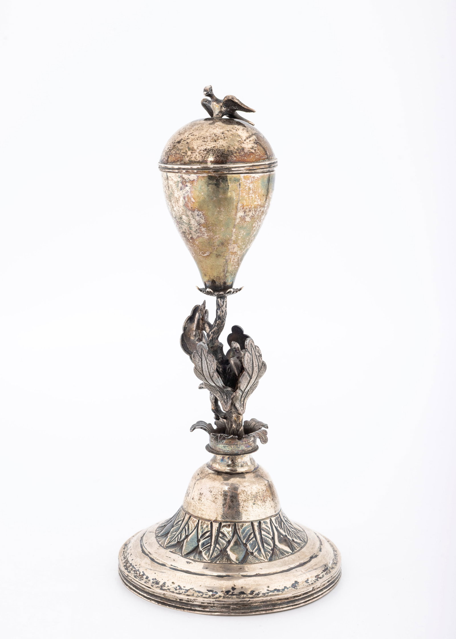 A LARGE SILVER SPICE CONTAINER. Most likely Poland.: On a round hand chased base with floral an leaf encrusted stem that attaches to a large pomander shaped spice section topped by a bird. 7.7" tall and 167 grams