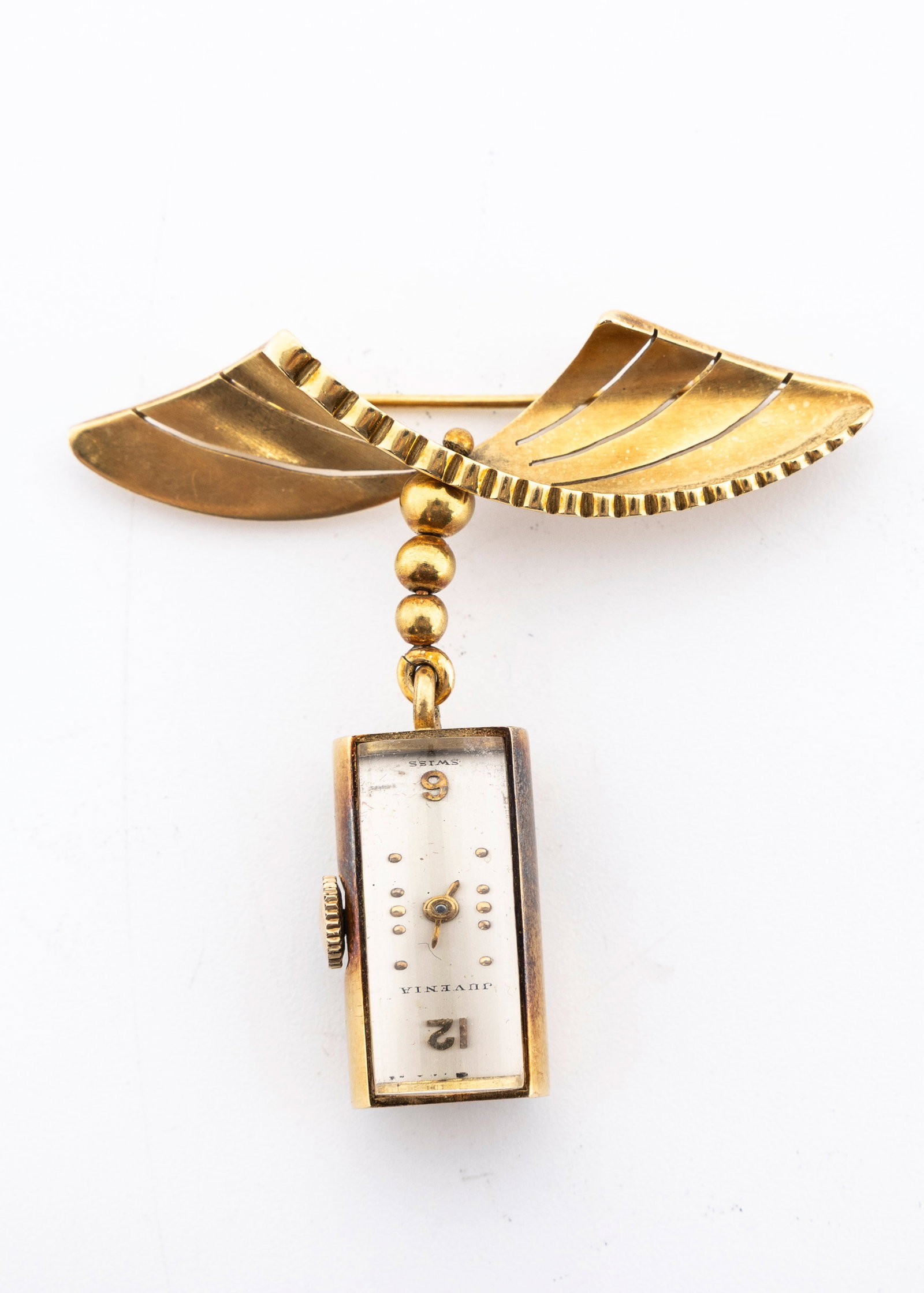 AN 18K GOLD BROOCHE WITH A DECO WATCH.: The watch by Juvenia and just about 1" long. Overall width is 2.1" and overall legnth is 2" long. Total weight including the movement is 22.1 grams