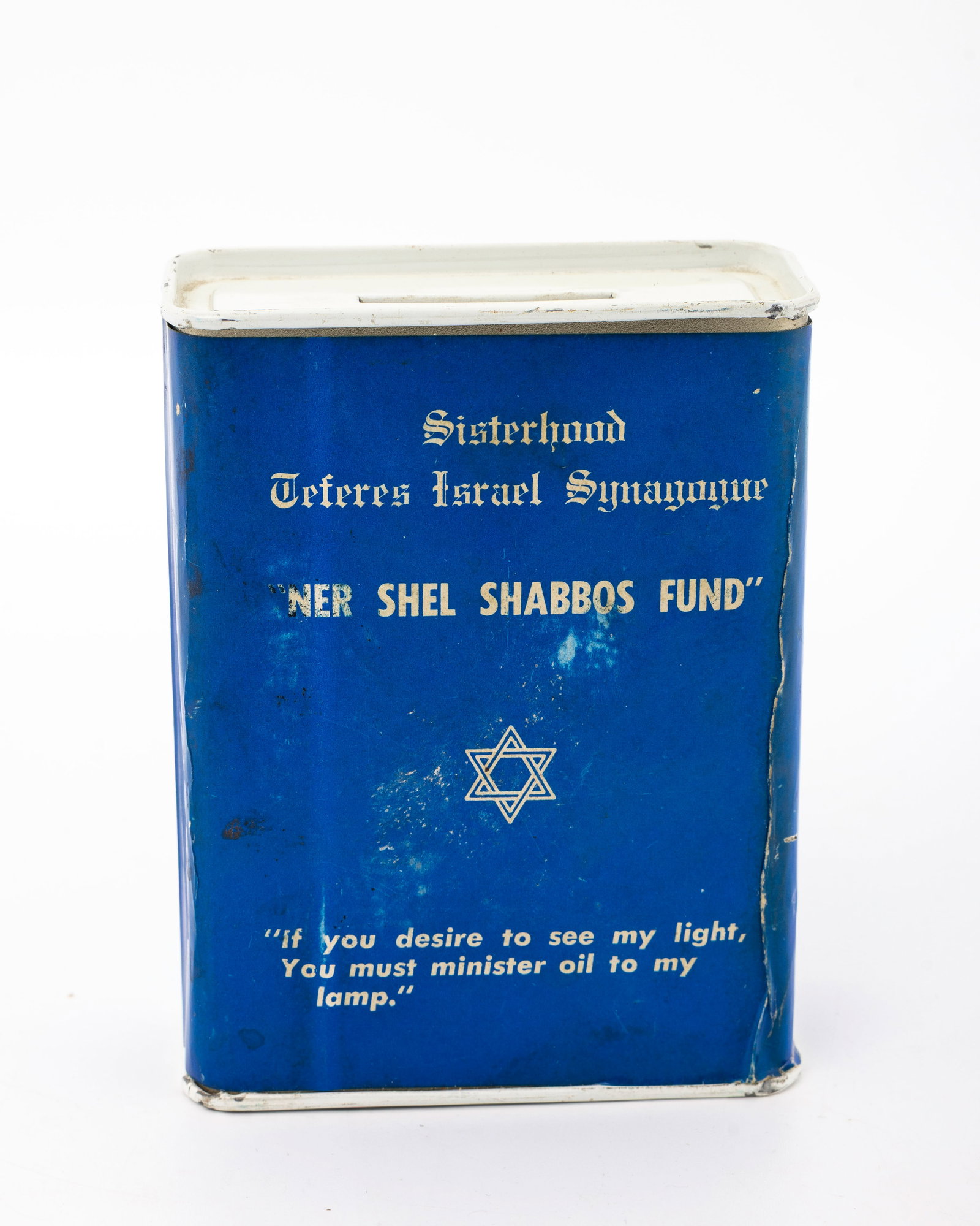 A TIN CHARITY CONTAINER COLLECTING FUNDS FOR THE TEFERRES ISRAEL SYNAGOGUE.: c. 1950. Blue with white print. Specified for the Sabbath Candle fund.