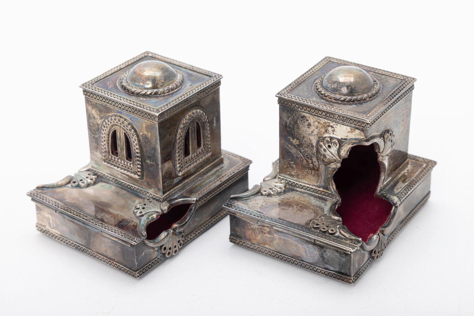 A PAIR OF SOLID STERLING SILVER TEFILLIN CASES. Probably Israel, modern: Hand wrought. In the shape of synagogues of Jerusalem. Unmarked but tested. 369 grams 3.2" x 2.4" x .6" (base). The upper portion is 1.6" x 1.6" x 1.6"