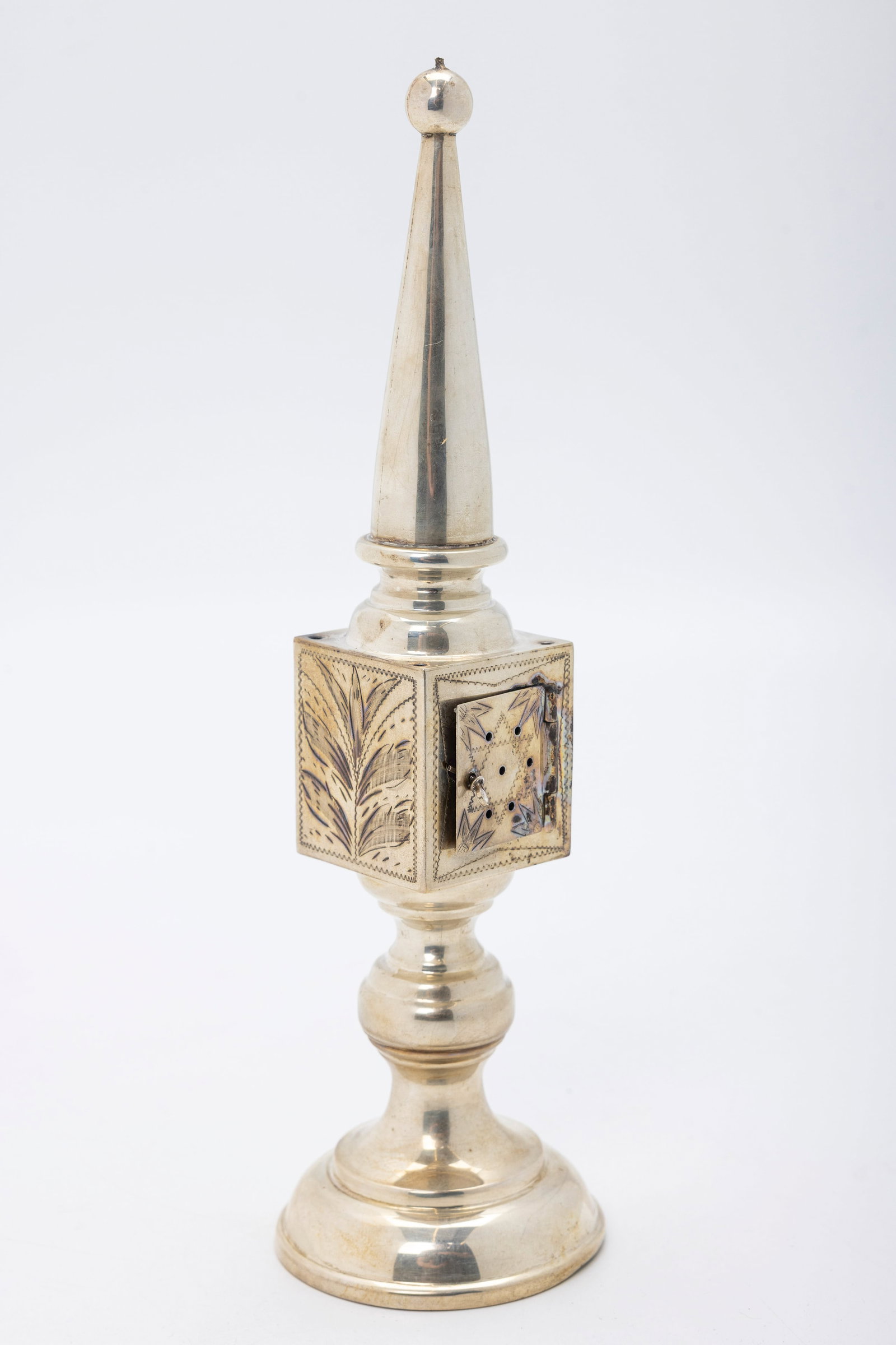 A SILVER SPICE TOWER. Germany, c. 1910: On a domed round base with a knobbed stem that attaches to a box shaped spice section pierced and engraved. Lacking flags. 8.8" tall. Marked 835. 82 grams