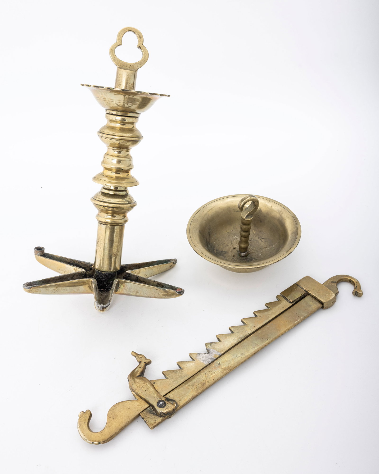 A COMPLETE BRASS JUDENSTERN. Germany, c. 1800: Complete with rachet and drip pan. 31" combined unextended.