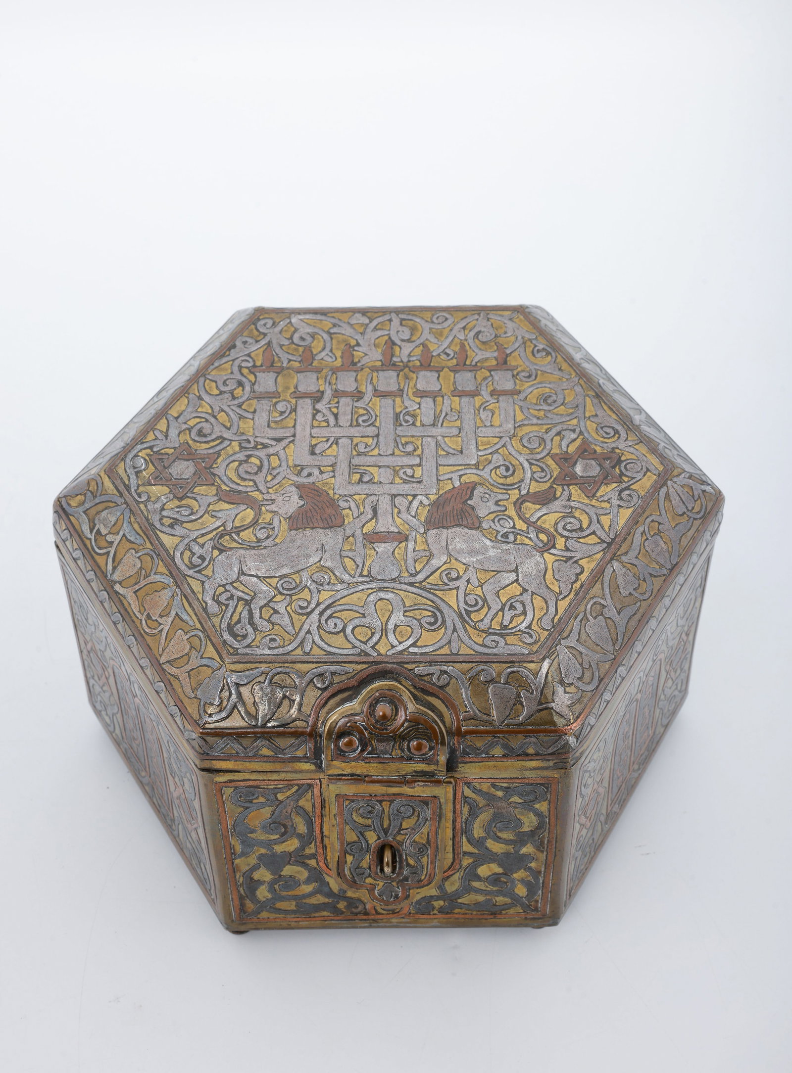 A LARGE OCTAGONAL DAMASCENE BOX. Israel, 20th century.: The top decorated with two lionsflanking a menorah. The sides are decorated with the Luchot, baskets and foliate designs. 6" tall and 8.2" wide. Lacking one foot.