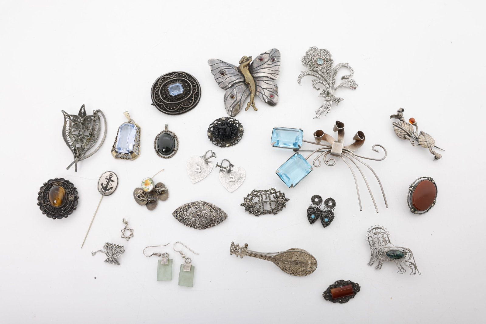 A GROUP OF 20 PIECES OF STERLING SILVER JEWELRY: Including pins, pendants, brocches, cufflinks. Total weight is 185 grams including the stones.
