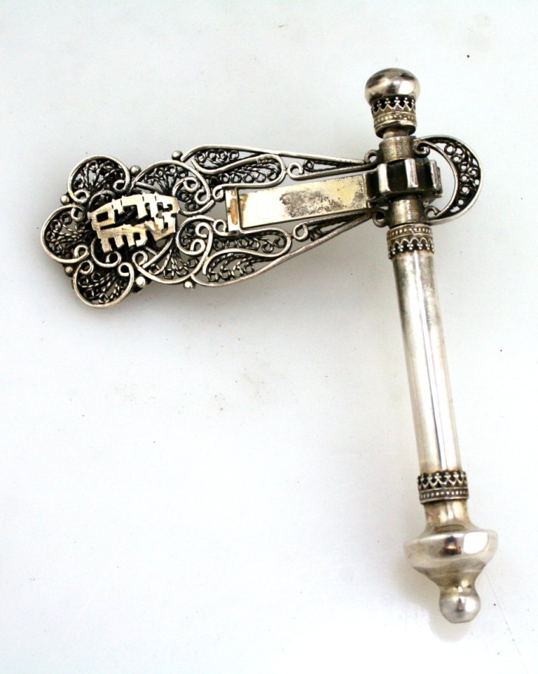 A SILVER GRAGGER. Probably Israel, 20th century. On tub: A SILVER GRAGGER. Probably Israel, 20th century. On tubular stave with filigree upper portion. Marked. 4.2” tall.