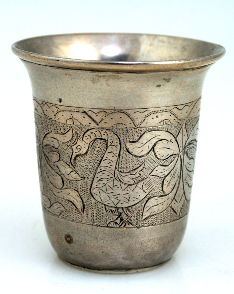 A SILVER KIDDUSH BEAKER. Poland, c. 1820. Engraved with: A SILVER KIDDUSH BEAKER. Poland, c. 1820. Engraved with zoomorphic and foliate designs. Marked 12. 2.5” tall.