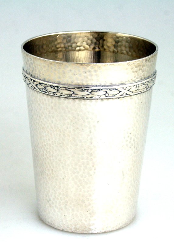 A SILVER KIDDUSH BEAKER. Germany, c. 1900: A SILVER KIDDUSH BEAKER. Germany, c. 1900. Hand hammered. Marked WTB, 800 crown and moon. Engraved on bottom with former owner’s name Dudek Grobmutter. 3.2” tall.