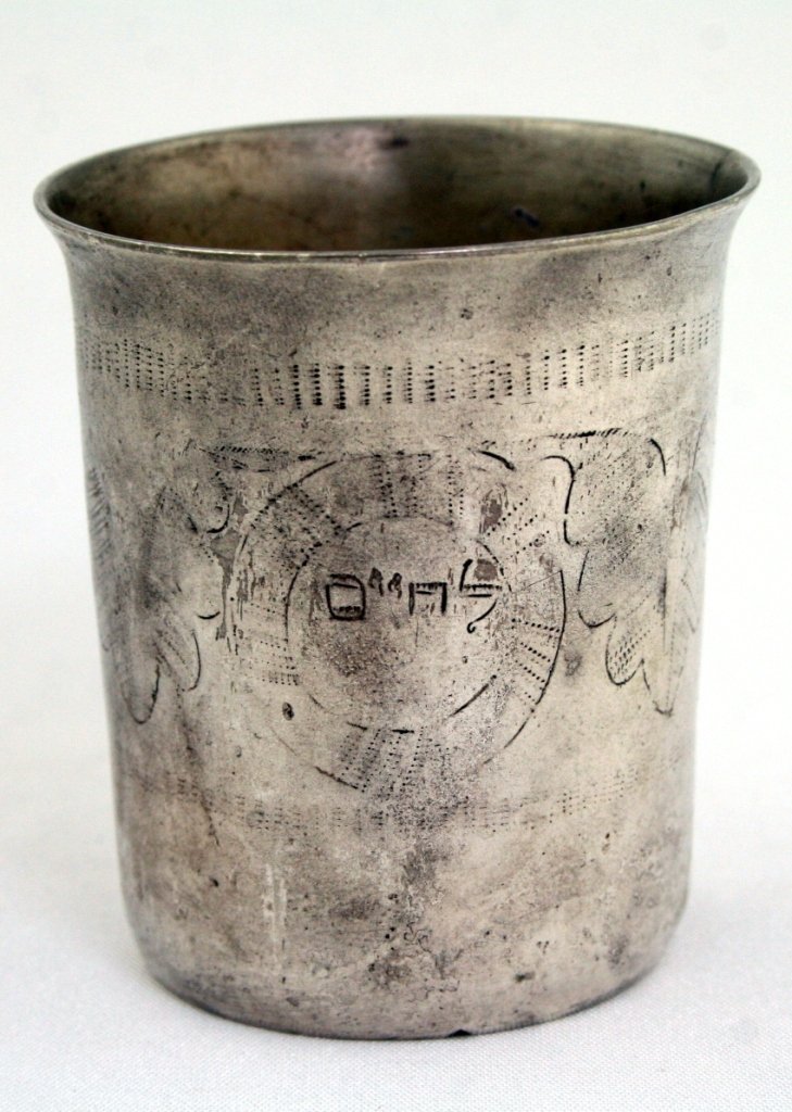 A SILVER KIDDUSH BEAKER. Probably Ukraine, c. 1820.: A SILVER KIDDUSH BEAKER. Probably Ukraine, c. 1820. Engraved with Hebrew word “lechaim". Marked with 12. Worn design. 2.5" tall. Estimate $800 - 1,200