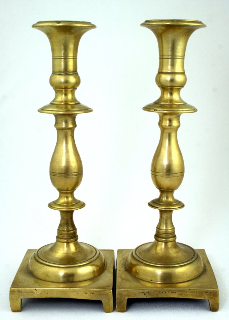 A PAIR OF BRASS SABBATH CANDLESTICKS. Russia, 19th: A PAIR OF BRASS SABBATH CANDLESTICKS. Russia, 19th century. On square bases with baluster shaped stems. 10.5" tall. Estimate $100 - 200