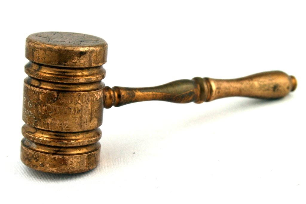 A BRASS GAVEL. United States, c. 1930. Engraved â€œTO: A BRASS GAVEL. United States, c. 1930. Engraved “TO RABBI ALBERT GORDON AS A TOKEN OF GRATITUDE FROM THE ROCKLIN FAMILY". Additionally engraved with a menorah and a Jewish star. 5.3" long. Estimate 