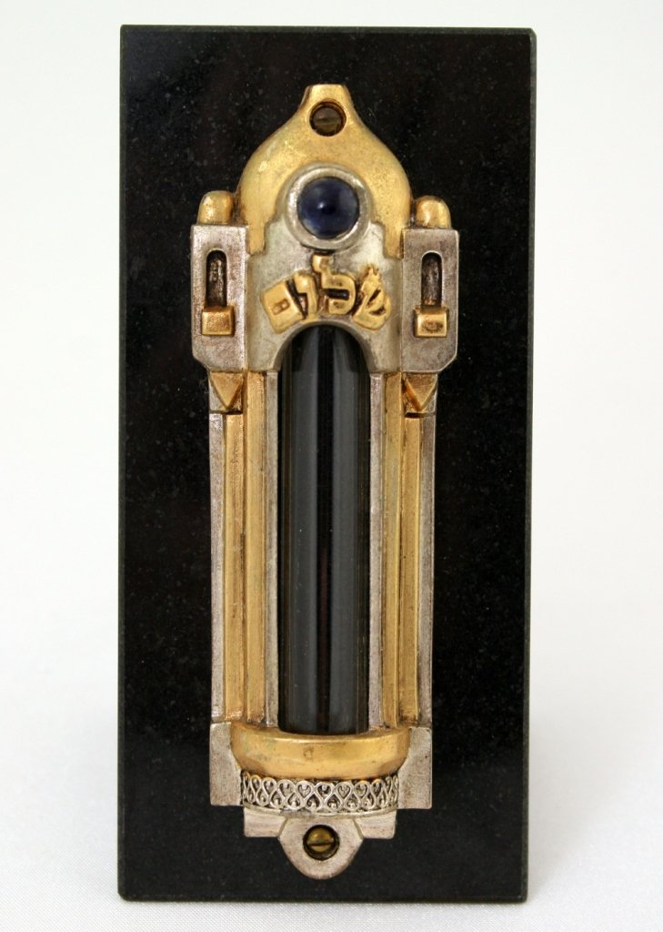 A MEZUZAH BY FRANK MEISLER. Israel, c. 1980. On a black: A MEZUZAH BY FRANK MEISLER. Israel, c. 1980. On a black stand. Decorated with blue glass. 4.3" tall. Estimate $100 - 200
