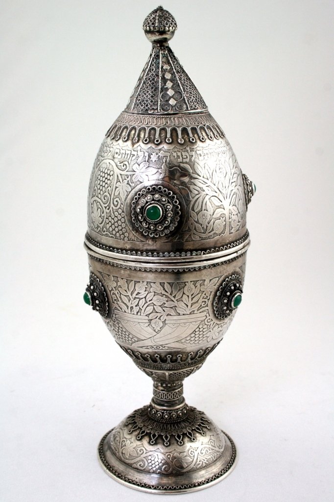 A LARGE SILVER ETROG HOLDER BY BEZALEL. Jerusalem,: A LARGE SILVER ETROG HOLDER BY BEZALEL. Jerusalem, 1950's. Decorated with acid etching, applied filigree designs and stones. Signed. Estimate $900 - 1,200