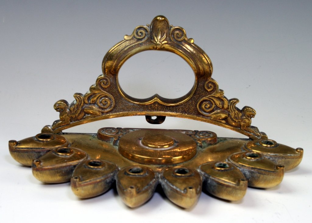 AN EARLY ISRAEL PALL-BELL MENORAH AND A DUTCH LAMP. The: AN EARLY ISRAEL PALL-BELL MENORAH AND A DUTCH LAMP. The Pall bell lamp missing it's shammos and the Dutch lamp missing it's oilers. Estimate $100 - 200