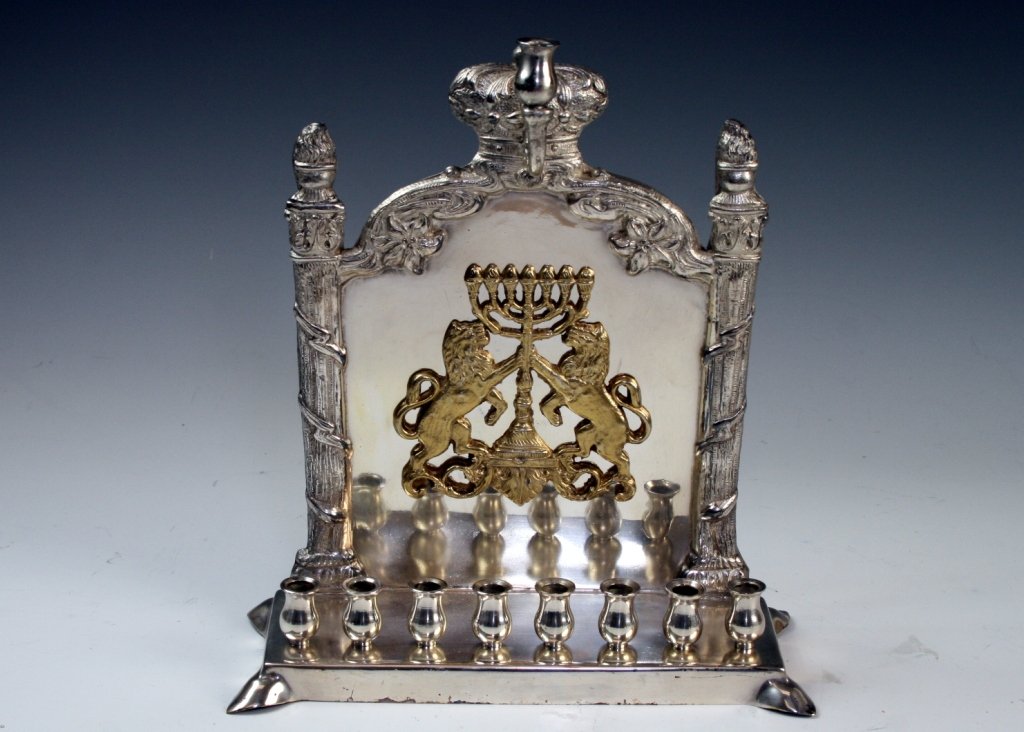 A SILVERPLATED CHANUKAH LAMP. Probably London, 20th: A SILVERPLATED CHANUKAH LAMP. Probably London, 20th century. Decorated with two lions flanking a menorah. 9.7" tall. Estimate $150 - 250