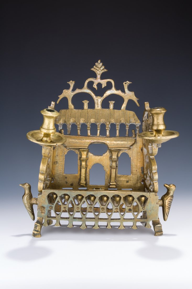 AN EARLY BRASS CHANUKAH LAMP. Poland or Ukraine, c.: AN EARLY BRASS CHANUKAH LAMP. Poland or Ukraine, c. 1800. In the shape of a wooden synagogue façade. 13” tall. Estimate $6,000 – 8,000