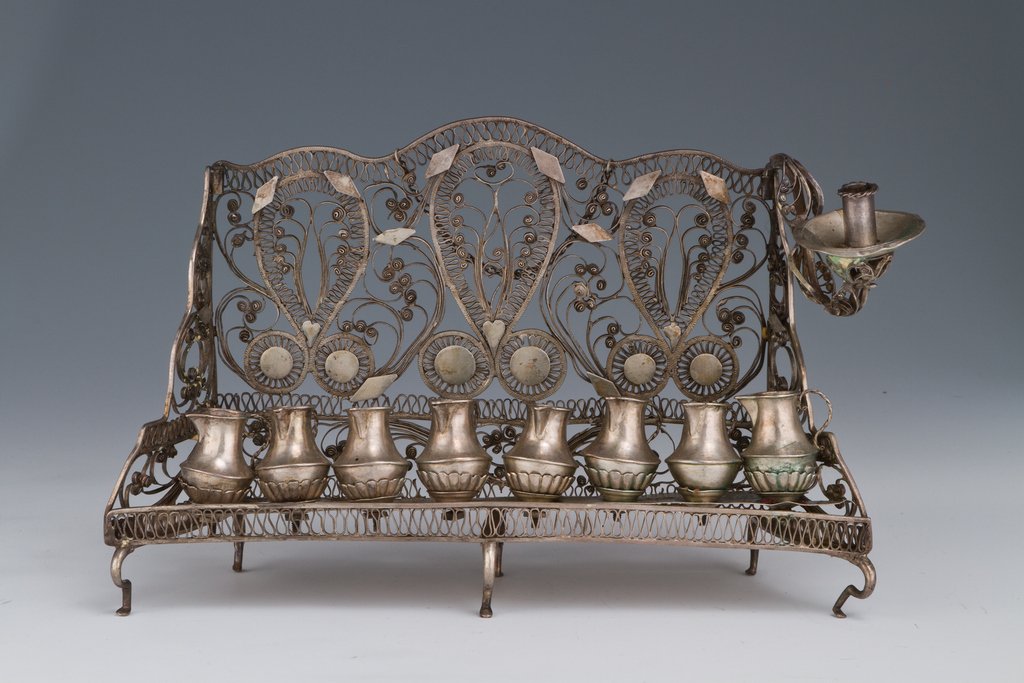 A SILVER CHANUKAH LAMP. Ukraine, c.1820. In Baal Shem: A SILVER CHANUKAH LAMP. Ukraine, c.1820. In Baal Shem Tov style. Made completely of filigree. 6.4” tall. Estimate $5,500 – 7,500