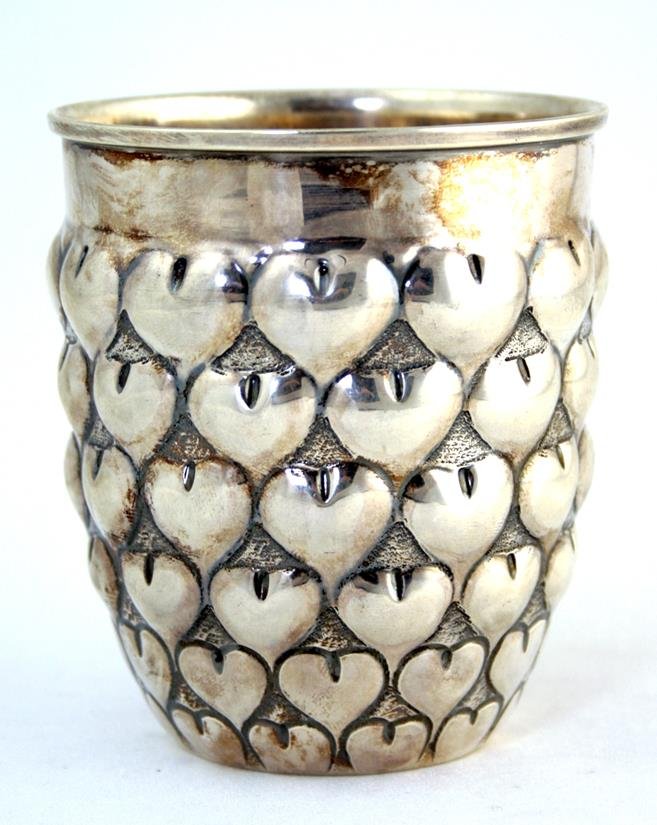 A LARGE STERLING SILVER KIDDUSH CUP BY TIFFANY AND: A LARGE STERLING SILVER KIDDUSH CUP BY TIFFANY AND COMPANY. New York, c. 1980. Chased with hearts. Marked. 3.8” tall.