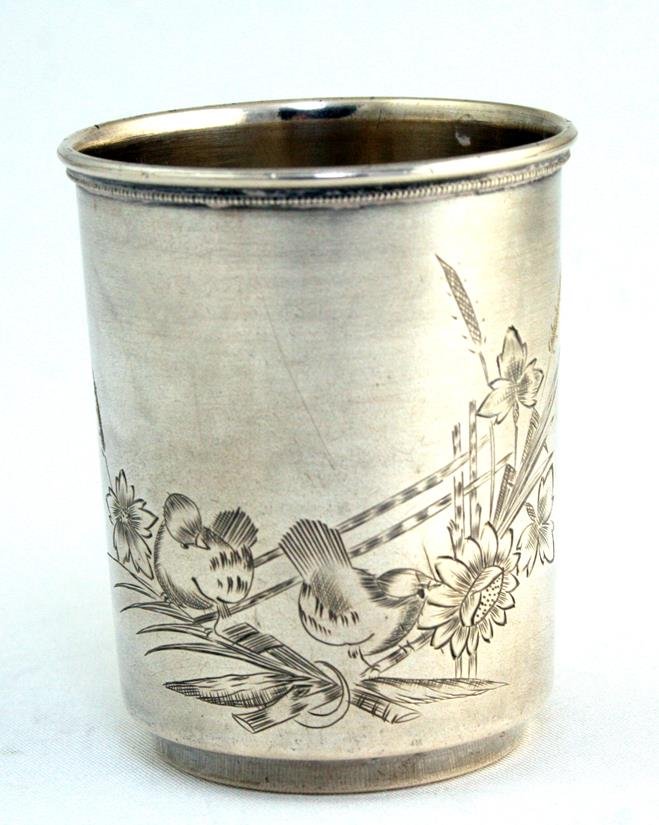 A SILVER KIDDUSH BEAKER. Russian, c. 1890. In art novae: A SILVER KIDDUSH BEAKER. Russian, c. 1890. In art novae décor. Marked with an 84 and a maker. 2.5” tall.