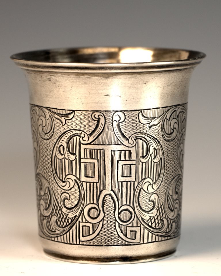 A SILVER KIDDUSH BEAKER. Russian, 1847. Hand engraved: A SILVER KIDDUSH BEAKER. Russian, 1847. Hand engraved with asymmetrical designs. Marked. 2.5” tall.