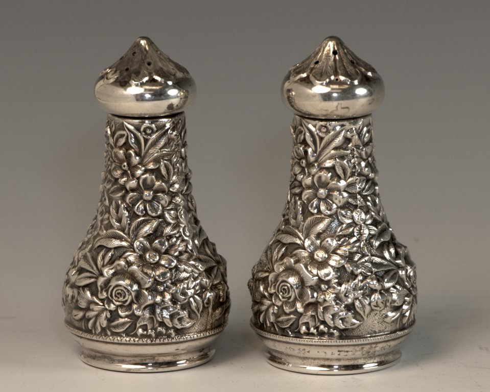 A STERLING SILVER SALT AND PEPPER BY KIRK. USA, c.: A STERLING SILVER SALT AND PEPPER BY KIRK. USA, c. 1940. Chased with floral design. 3” tall.