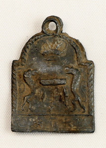 A LEAD AMULET. Poland, 19th century. With two: A LEAD AMULET. Poland, 19th century. With two mythological creatures flanking an Heh. 1” tall. Estimate $100 – 200