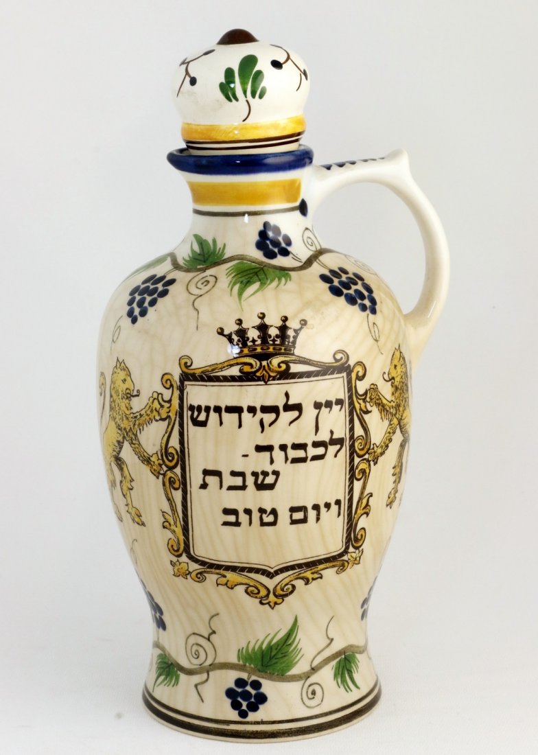 A CERAMIC WINE BOTTLE. The Netherlands, mid 20th: A CERAMIC WINE BOTTLE. The Netherlands, mid 20th century. Hand painted with Hebrew lettering. Signed. 10.3Ó tall.