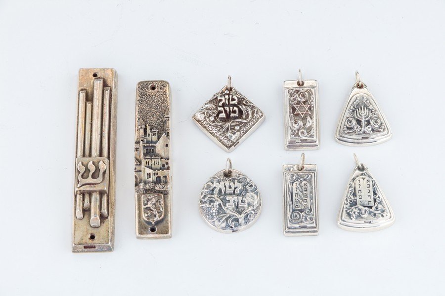 TWO STERLING MEZUZOT AND SIX PENDANTS BY HENRYK (1 of 1)