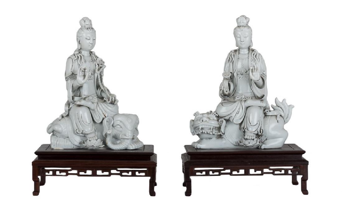 PAIR OF CHINESE BLANC DE CHINE PORCELAIN GUAN YIN: impressed Chinese four-character seal mark; two-character signature; one depicted seated on an elephant the other on a guardian lion Provenance: The Estate of John Robert Weber 9 inches wide; 12 1/2 i