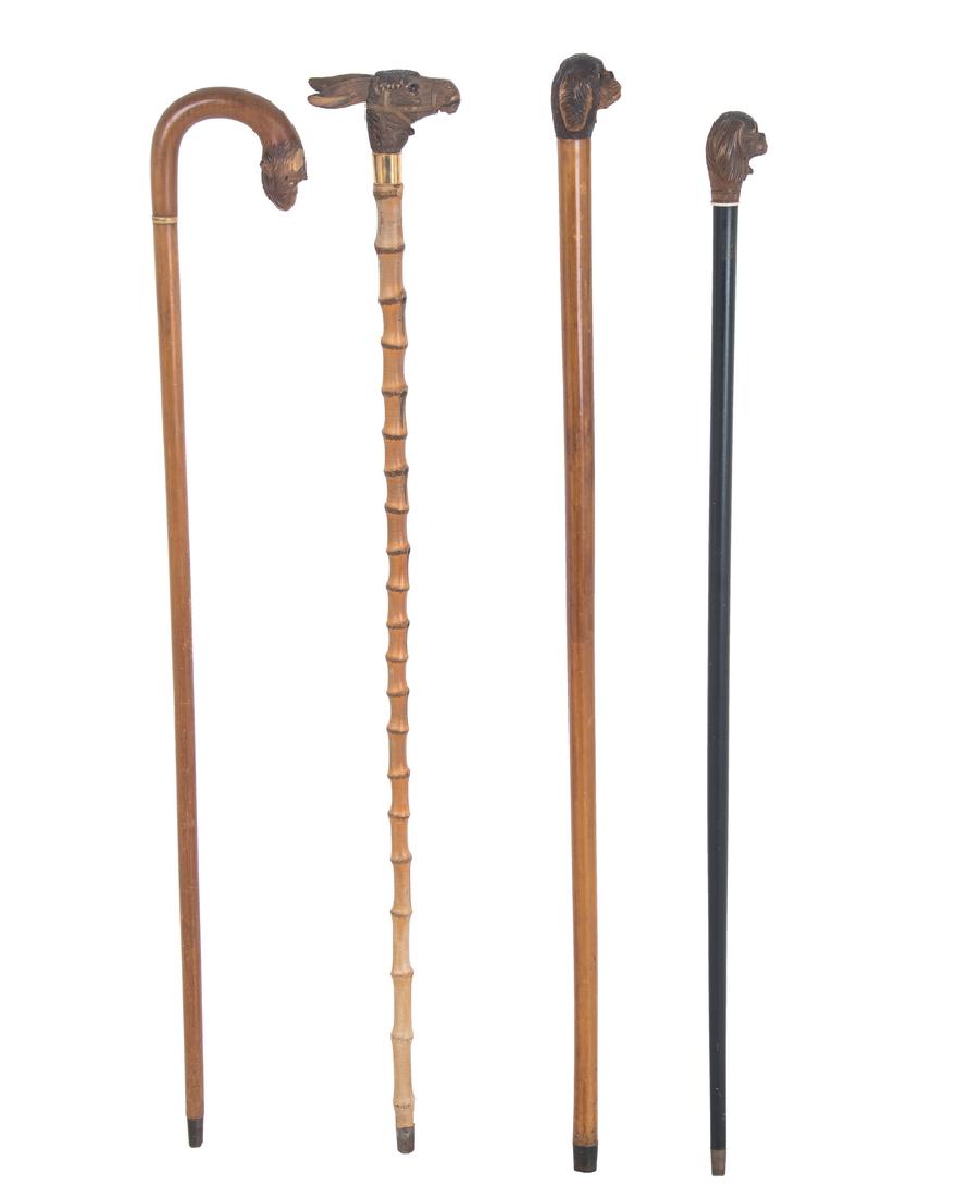 FOUR ASSORTED CANES WITH MOVABLE MOUTHS: comprising a monkey, a donkey, and two dogs the largest: 37 inches high