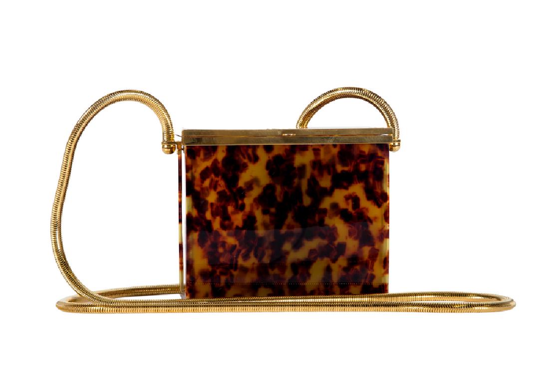 CHANEL TORTOISE RESIN EVENING BAG: rectangular structured box purse with hinged opening and long gold-tone snake chain strap, CC logo on top, snap closure and "Chanel 97" Made in France. 4 1/4 inches high; 5 inches wide; 2 1/2 inches d