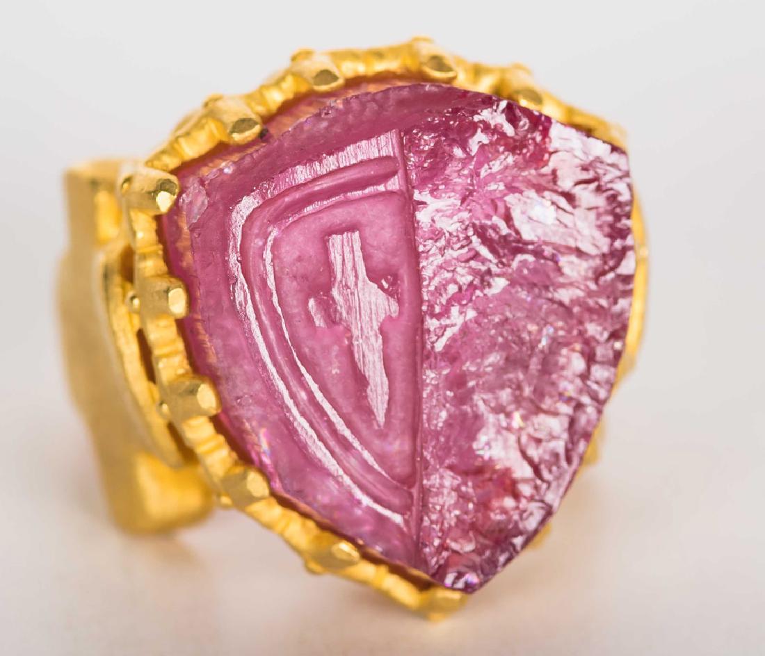 DENISE ROBERGE FOR ANDREW CLUNN 22 KARAT YELLOW GOLD &: stamped 'Denise Roberge 22K'; containing one carved pink tourmaline crystal depicting a sword motif and measuring approximately 24.45 x 21.63 x 9.24 mm set within a matte finish multi prong surround a