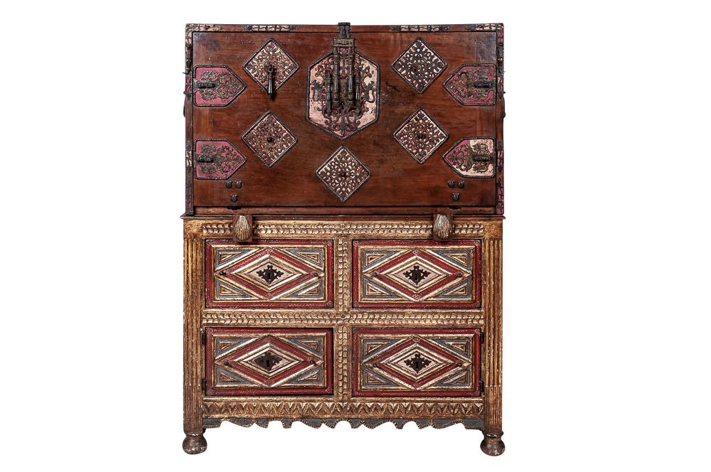SPANISH POLYCHROME, CARVED WALNUT, & PARCEL GILT: the upper part with a fall applied with velvet and pierced gilt iron work locking plate angles and carrying handles, enclosing various drawers with architectural loppers on a chest with bun feet Prove