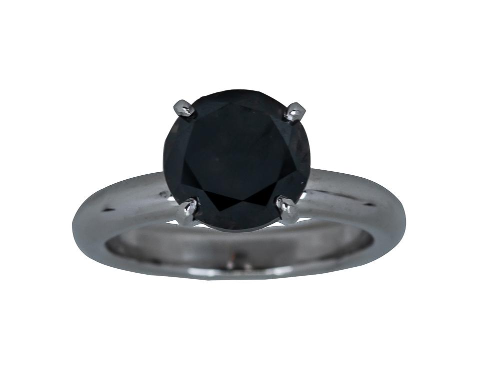 PLATINUM & BLACK DIAMOND RING: containing one black round brilliant cut diamond weighing approximately 2.62 carats 8.3 grams size: 5 3/4