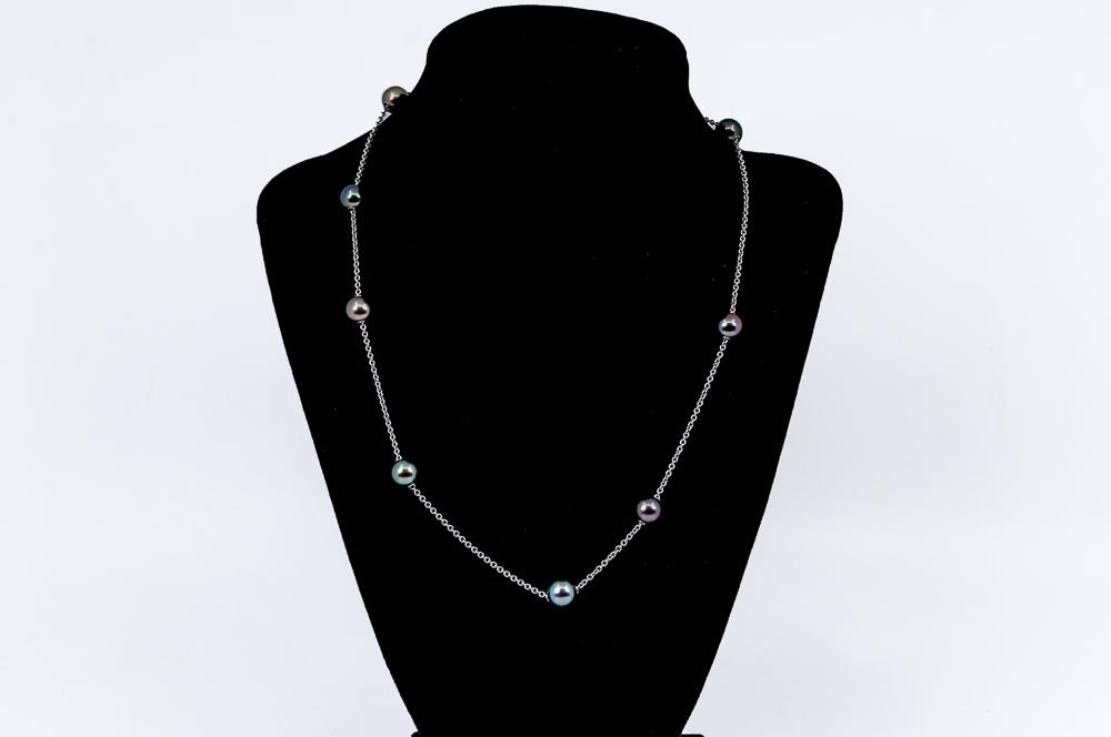 MIKIMOTO 18 KARAT WHITE GOLD, TAHITIAN PEARL, &: containing eleven bright grey to dark greenish gray cultured pearls measuring approximately 8.25-8.75 mm, and 15 blue sapphires weighing approximately 0.20 carats total 14.2 grams 18 1/2 inches long