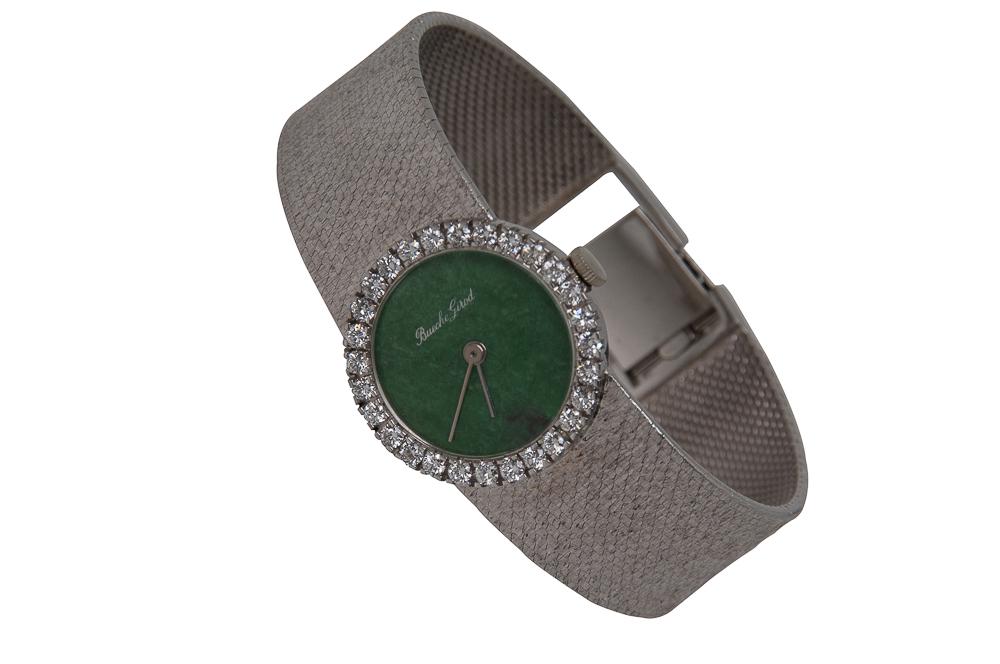 BUECHE-GIROD 18 KARAT WHITE GOLD, JADEITE JADE, &: containing one round tablet cut natural jadeite jade, 19.00 mm in diameter, and 29 full cut round diamonds [G/VS] weighing 1.26 carats total; the round jadeite minimalist dial signed 'Bueche-Girod' un