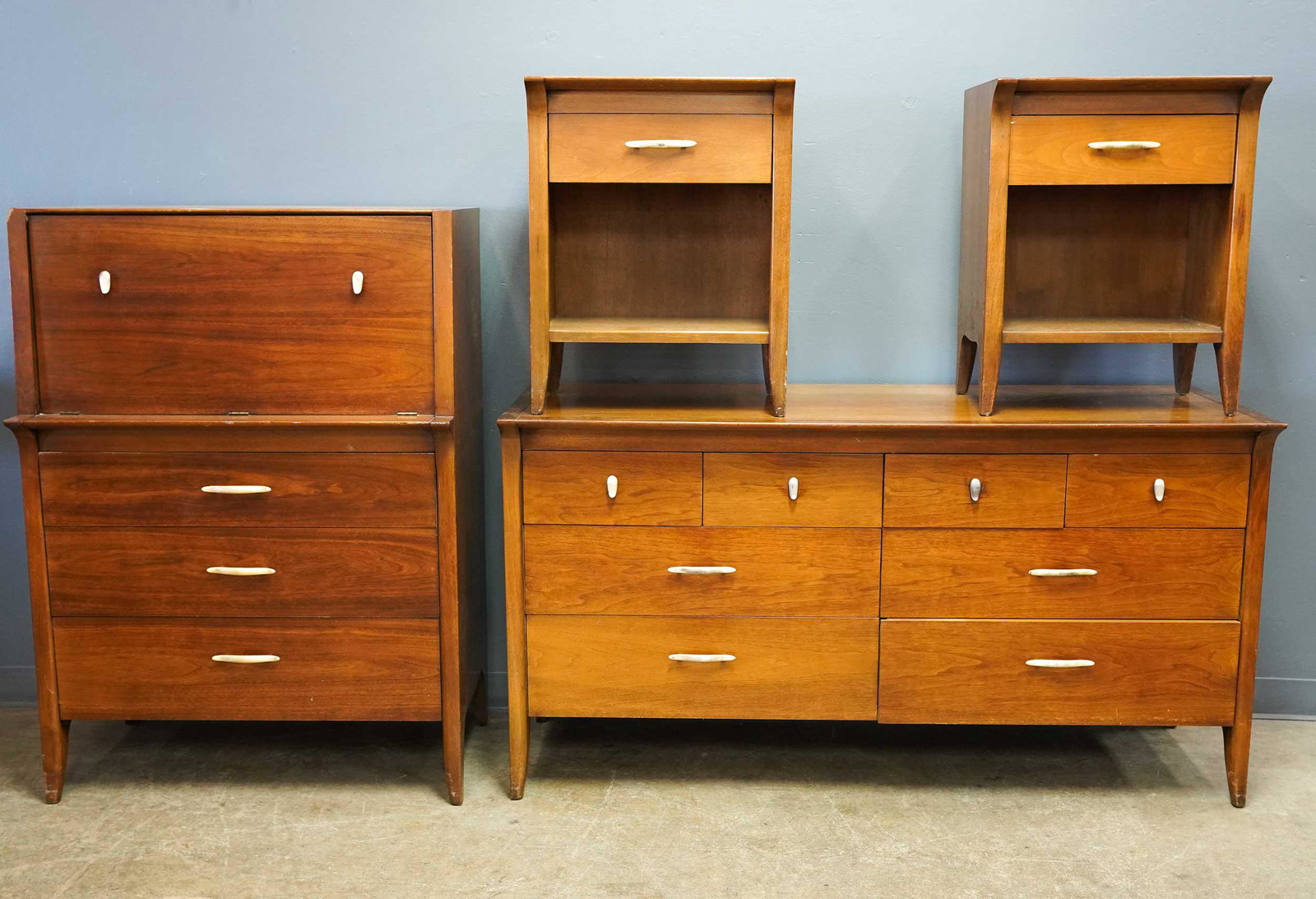 DREXEL MODERN FOUR PIECE BEDROOM SET: comprising dresser, two nightstands, and secretary chest the nightstands 20 inches wide; 14 inches deep; 25 1/2 inches high; the secretary 34 inches wide; 21 inches deep; 48 inches high Condition: wit
