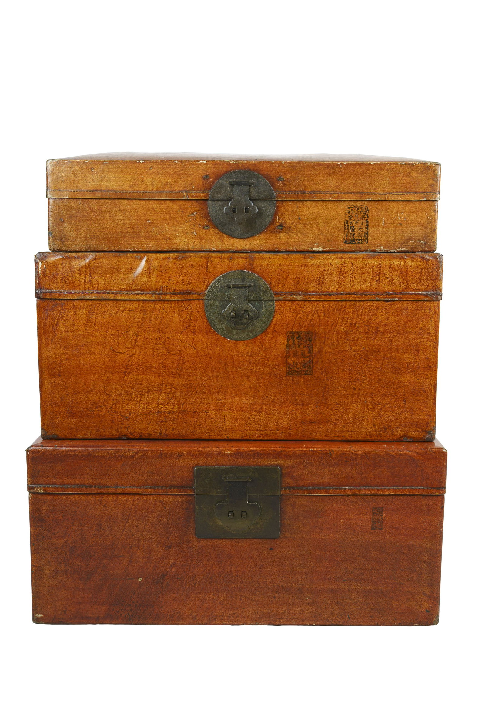 THREE CHINESE LACQUERED SKIN TRUNKS: graduating from 30 x 21 1/2 x 13 1/2 inches high; 28 1/2 x 18 1/2 x 13 1/2 inches high; 27 1/4 x 17 1/2 x 6 1/2 inches high