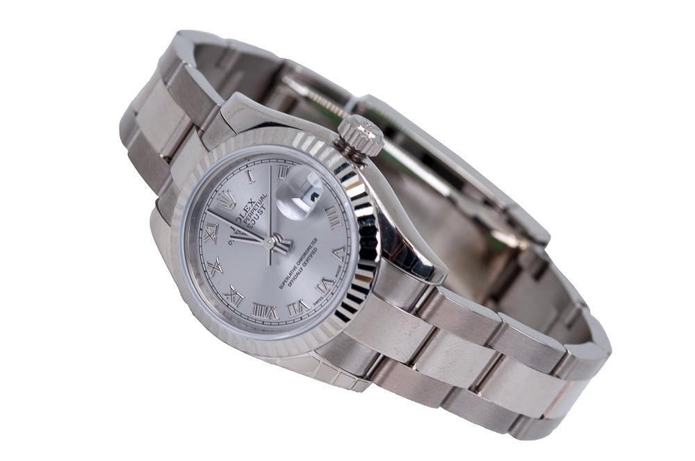 ROLEX OYSTER PERPETUAL DATEJUST 18 KARAT WHITE GOLD: ladyâ€™s silver dial, chapters, applied Roman Numeral, aperture at 3:00 for date, center sweep seconds hand; completed by an 18 karat white gold Oyster link bracelet Provenance: Carmel, CA Estate