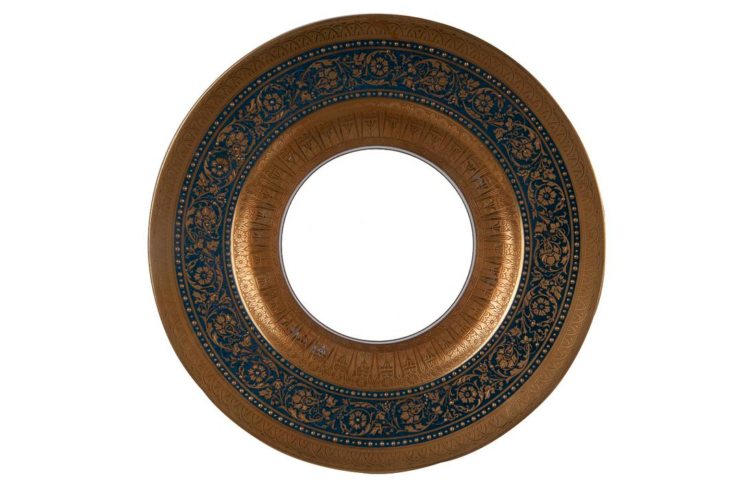 TWELVE ROYAL WORCESTER GILT DECORATED PORCELAIN SERVICE: circa 1923, retailed by Ovington Brothers Condition: Most with light wear to gilt decoration and minor scratches commensurate with light use. One with a repaired break spanning 10 1/2 inches, crack is