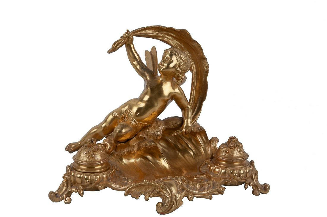 AUGUSTE MOREAU: FRENCH GILT BRONZE INKWELL: late 19th century signed "Aug. Moreau", inscribed "J'aime le Son d... Le Soir au Fond des O... s" Condition: a few dark marks and areas of minor surface wear. 9 3/4 inches wide; 5 inches deep; 7 inche