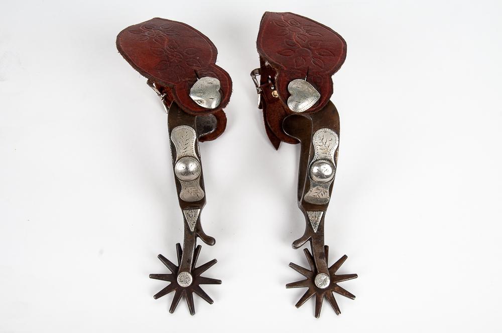 PAIR OF CROCKETT FRONTIER SPURS: with silver overlay 9 inches wide; 4 inches deep