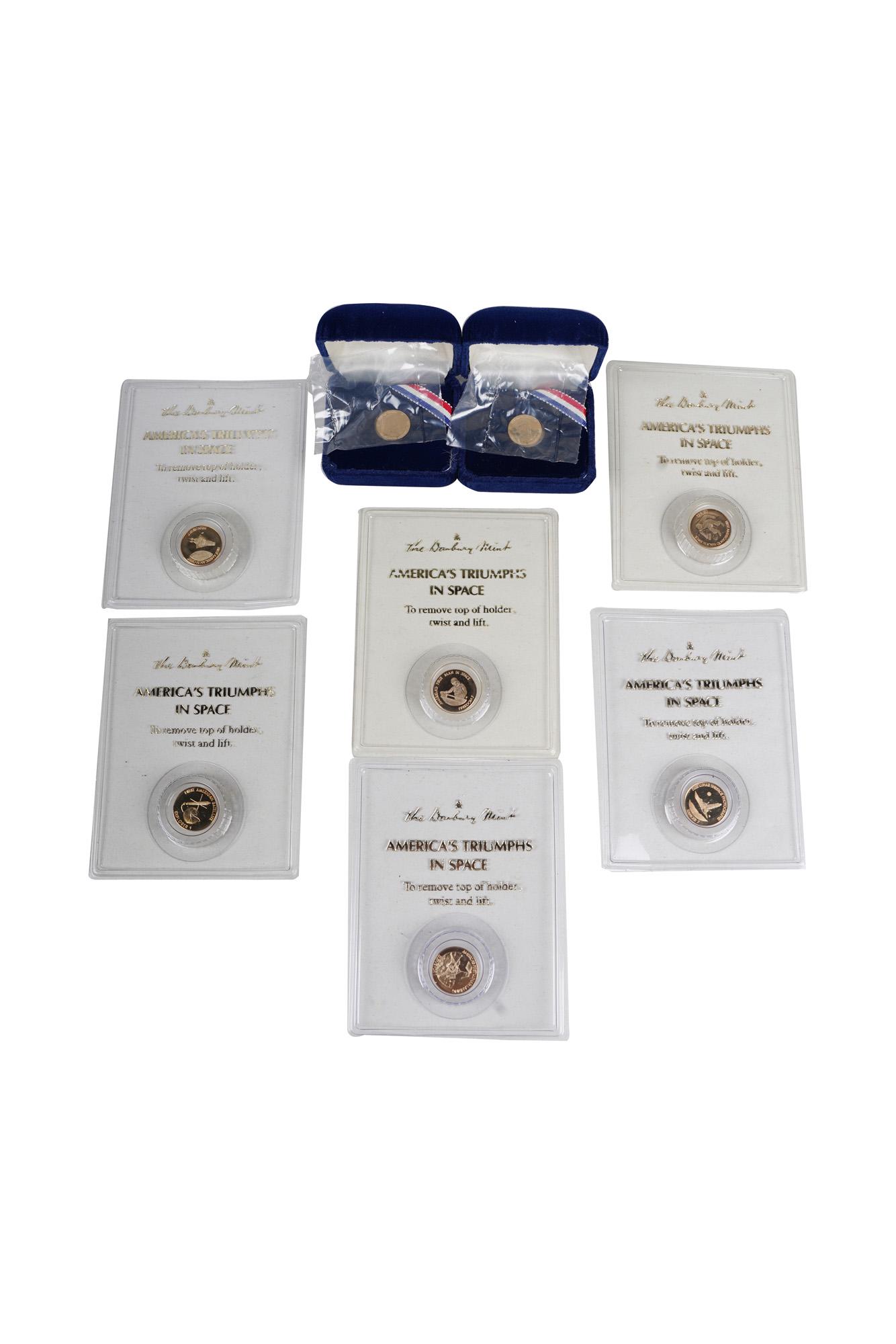 EIGHT DANBURY MINT 14 KARAT GOLD COMMEMORATIVE COINS: comprising six 'America's Triumphs in Space' and two 'Reagan 1st Inauguration' each in original packaging approximately 16.8 total grams