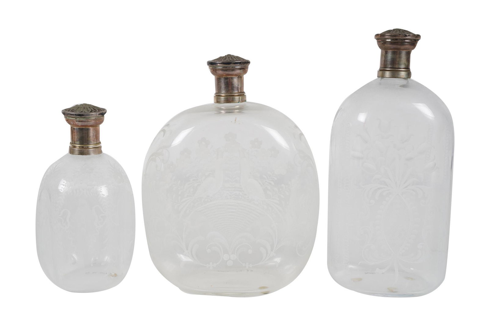THREE ETCHED GLASS BOTTLES: unmarked Condition: good. No chips the tallest 10 inches high