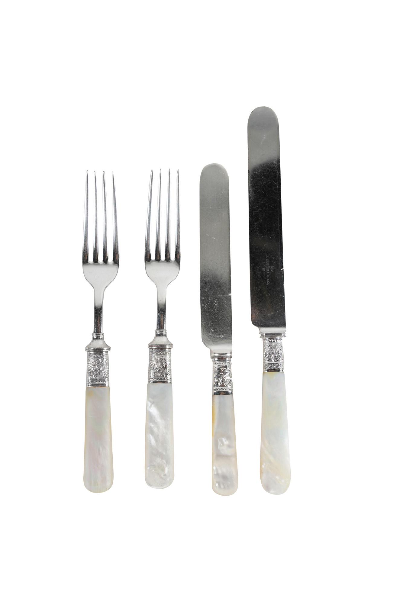 MOTHER OF PEARL & STAINELESS FLATWARE SERVICE: The knife blades variously marked, the forks unmarked nmarked, comprising six forks (7 1/4" long), six luncheon knives (7 3/4" long) and 11 dinner knives (9" long) [23 total pieces]